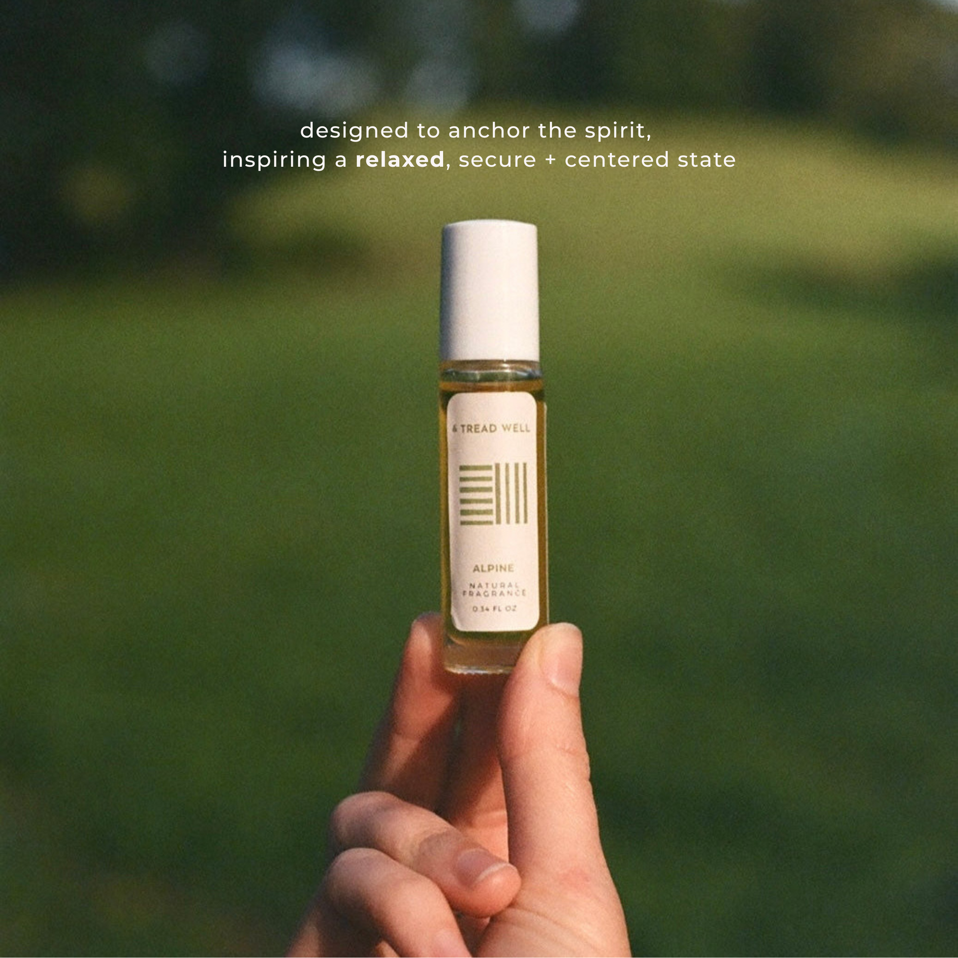 Hand holding a small bottle with a blurred green background