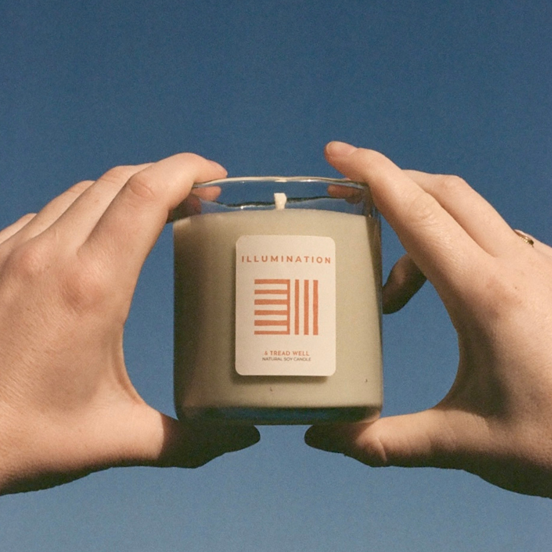 Two hands holding a candle labeled 'Illumination' against a blue background