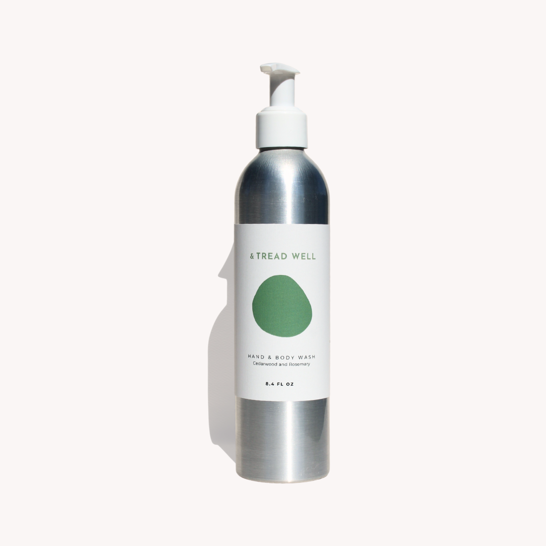 Bottle of hand and body wash with a white pump on a white background